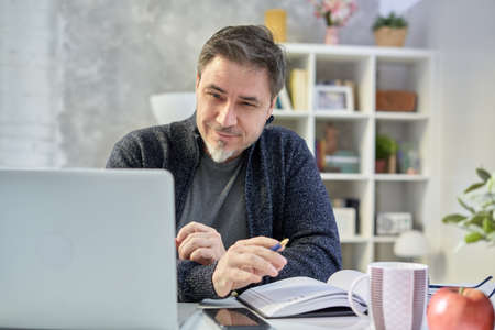 Man working with laptop at home officeの写真素材