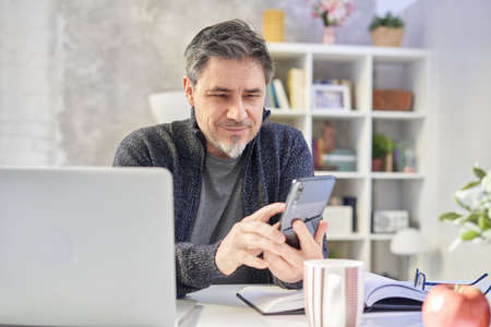 Man working with laptop at home officeの写真素材