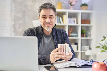 Man working with laptop at home officeの写真素材