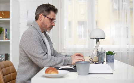 Man working with laptop at home office