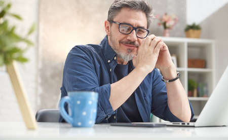 Man working with laptop at home officeの写真素材