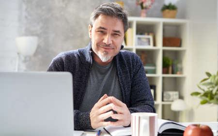 Man working with laptop at home officeの写真素材