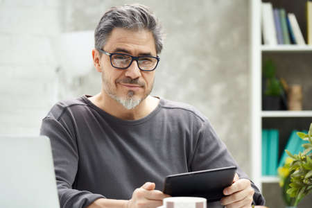 Man working with laptop at home officeの写真素材