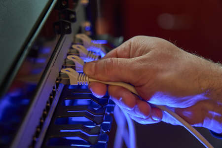 IT expert working with computer server network cableの写真素材