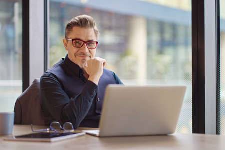 Businessman working with laptop in officeの写真素材