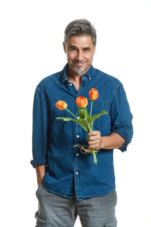 Casual older white man with flowers isolated on whiteの写真素材