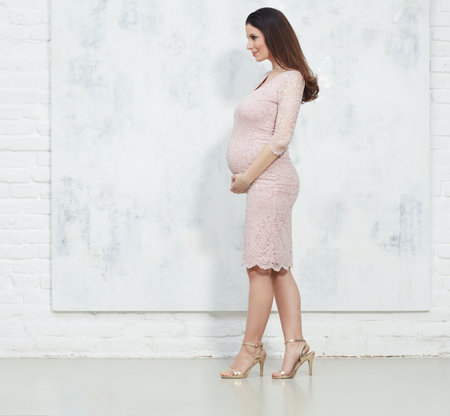 Happy pregnant woman in elegant dressの写真素材