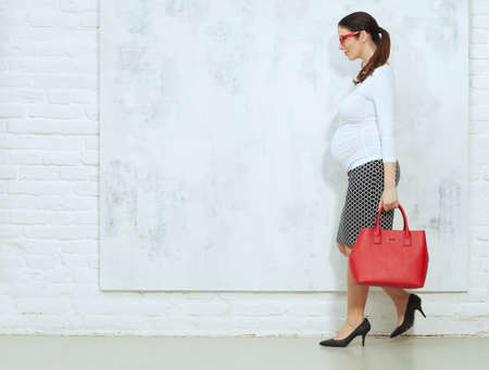 Pregnant woman in business casualの写真素材