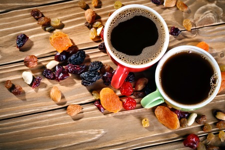 Green and red ceramic cups stand on wooden boardsの写真素材