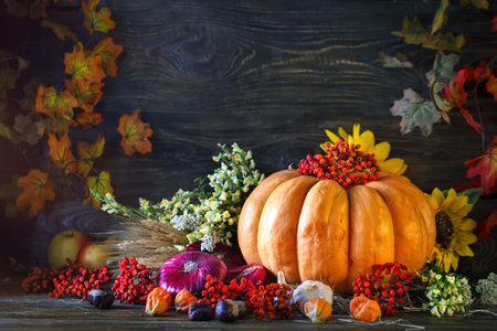 The wooden table decorated with vegetables, pumpkins and autumn leaves. Autumn background....