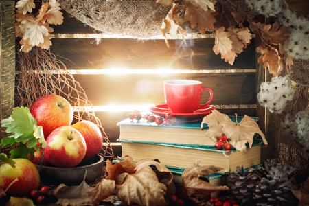 Autumn still life with a cup of coffee, apples and autumn leaves. Autumn background.の写真素材
