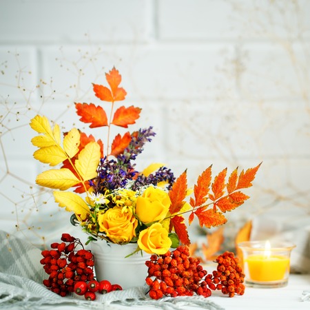 Autumn leaves and flowers on a wooden table. Autumn background with copy space. Autumn still life.の写真素材