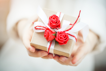 Mothers Day. Gift in hands of the little girl, Selective focus.の写真素材