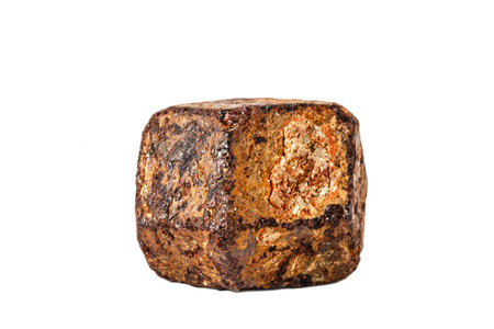 Macro shooting of natural gemstone. The raw mineral is garnet, Madagascar. Isolated object on a white background.の写真素材