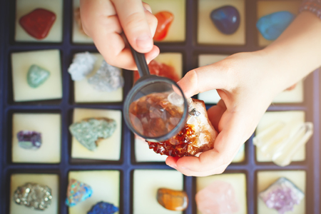 The child looks at his collection of minerals. The little geologist.の写真素材