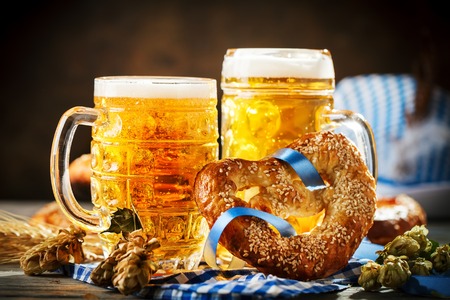 Beer mugs and pretzels on a wooden table. Oktoberfest. Beer festival.の写真素材
