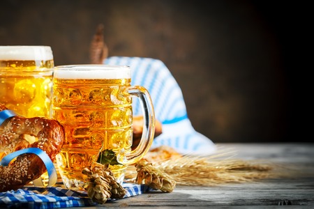 Beer mugs and pretzels on a wooden table. Oktoberfest. Beer festival.の写真素材