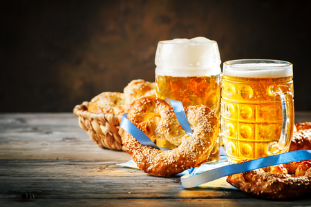 Beer mugs and pretzels on a wooden table. Oktoberfest. Beer festival.の写真素材