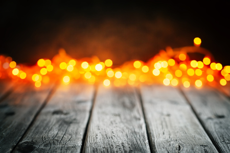 Wooden table on Christmas lightsの写真素材