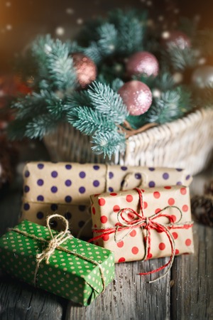 Basket with Christmas toys and Christmas gifts on a woodenの写真素材