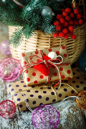 Merry Christmas and happy new year. Basket with Christmas toys and Christmas gifts on a woodenの写真素材