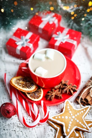 Merry Christmas and happy New year. Cup of cocoa, cookies, gifts and fir-tree branches on a white wooden table. Selective focus. Christmas background. Vertical.の写真素材