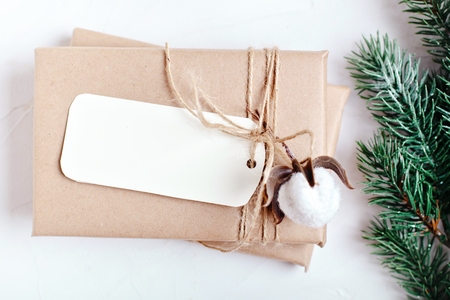 Merry Christmas and happy New year. Mockup with postcard and branches of a Christmas tree on white background. Background with copy space. Top view. Christmas background. Vertical.の写真素材