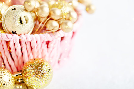 Merry Christmas and happy New year. Golden Christmas toys on a light background. Selective focus. Top view.の写真素材