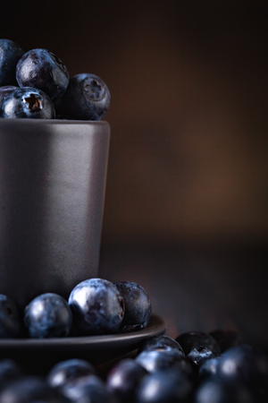 Blueberries in a Cup on a darkの写真素材
