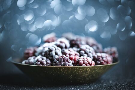Frozen blackberries on a wooden table. Horizontal. Background with copy space.の写真素材