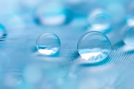 Beautiful transparent water drops or rain water on soft background. Macrophotography. Desktop...