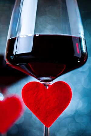Glasses of red wine on a beautiful bokeh background. Background with copy space. Selective focus. Vertical.の写真素材
