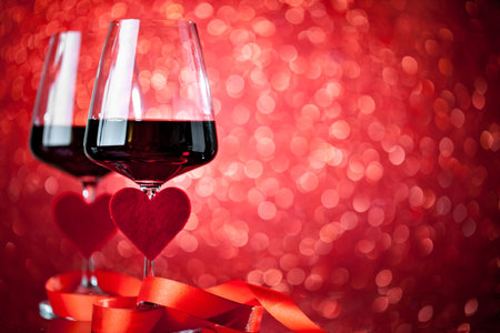 Glasses of red wine on a beautiful bokeh background. Background with copy space. Selective focus.の写真素材