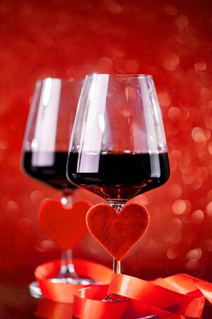 Glasses of red wine on a beautiful bokeh background. Background with copy space. Selective focus.の写真素材