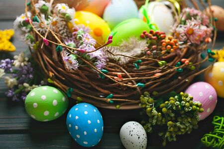 Happy Easter. Congratulatory easter background. Easter eggs and flowers. Background with copy space. Selective focus.の写真素材