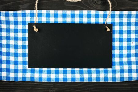 Blue checkered tablecloth and wooden appliances for cooking and baking. Background with copy space. Horizontal. Top view.の写真素材