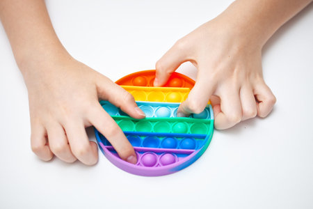 Silicone toy antistress in the hands of a teenager. Anti-stress colorful toy.の写真素材