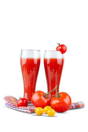 Two glasses with tomato juice and a small tomato on a bright background.の写真素材