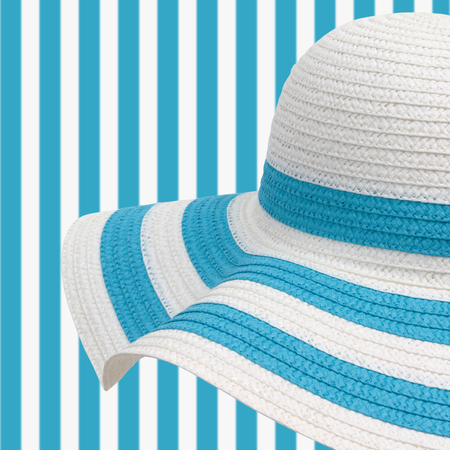 white and cyan beach hat on striped backgroundの写真素材