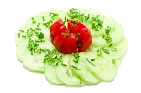salad with cucumber, tomato and chives over a white backgroundの写真素材