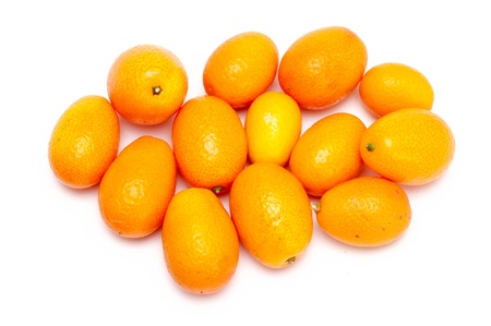 some fresh kumquats over a white backgroundの写真素材