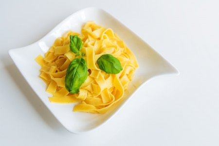 spaghetti & basil on plateの写真素材