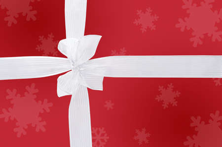 White satin ribbon over red paper gift boxの写真素材