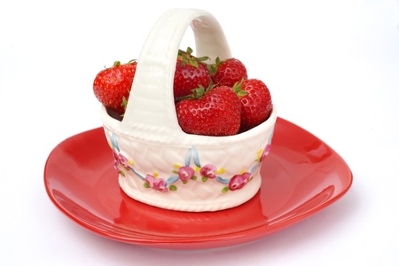 Strawberries in vase on white backgroundの写真素材