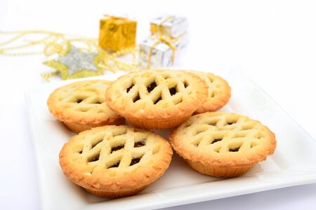 Mince pies and christmas decorations on white backgroundの写真素材
