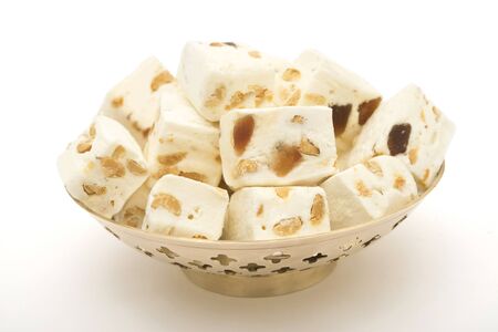 Nougat cubes in vase close up on white backgroundの写真素材