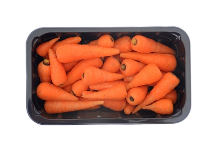 Raw carrots in black container isolated on white background の写真素材