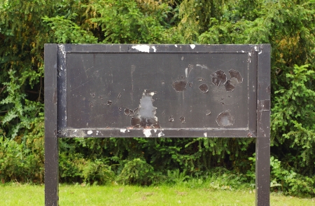 weathered grungy old notice board with paint cracking の写真素材