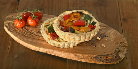 roasted vegetable quiche and tomatoの写真素材