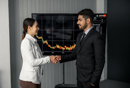 Financial advisors collaborate to assess a company's financial performance using data from its operational activities. Team members work together in a discussions meeting to develop a business plan.の写真素材